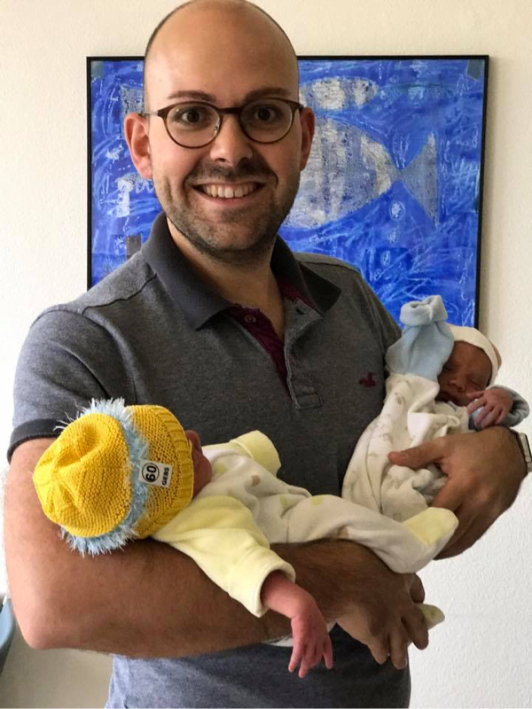 Manuel holding his newborn twins